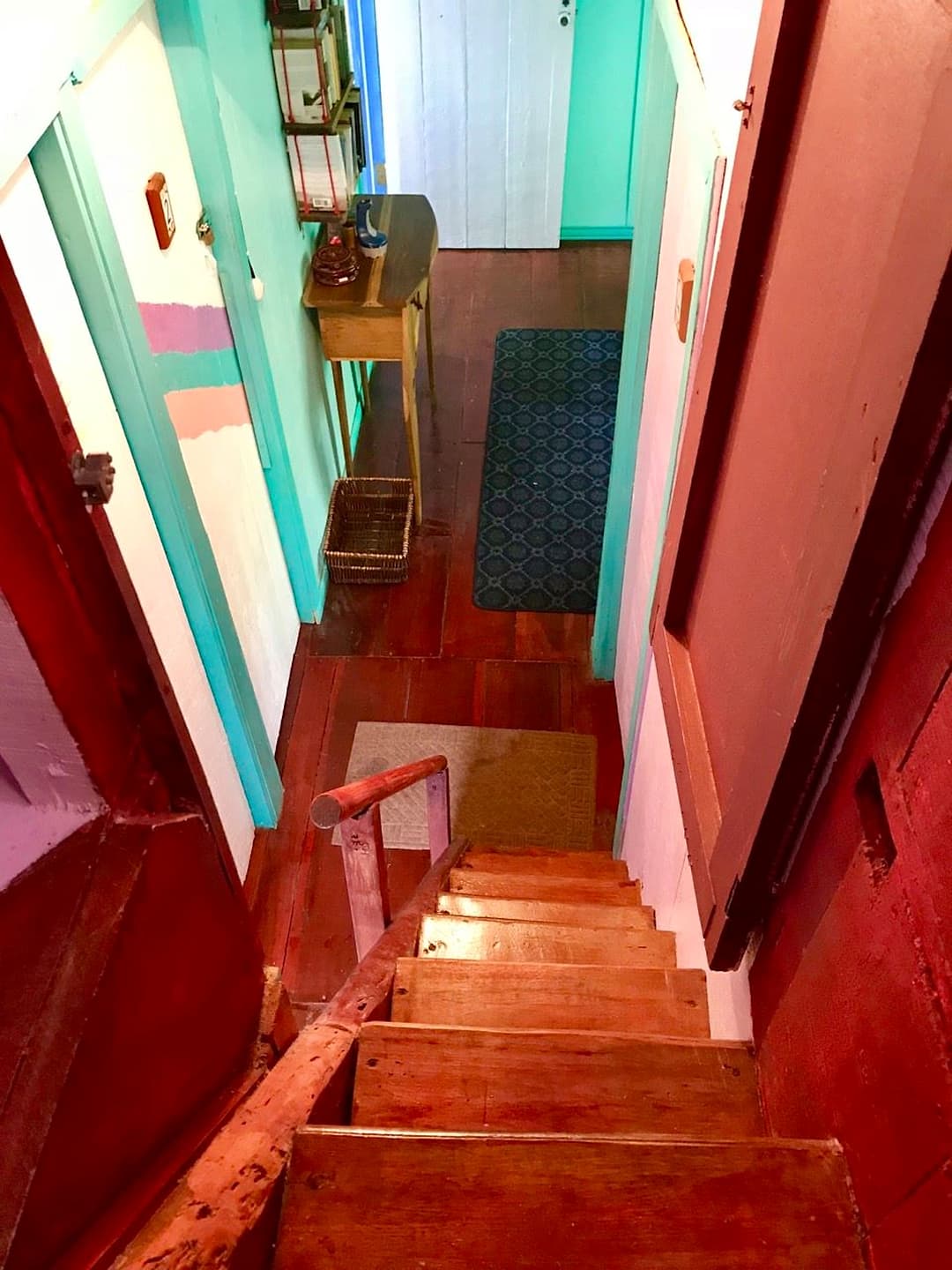 Looking down the narrow staircase from the Treetop Balcony Room, with its handrail